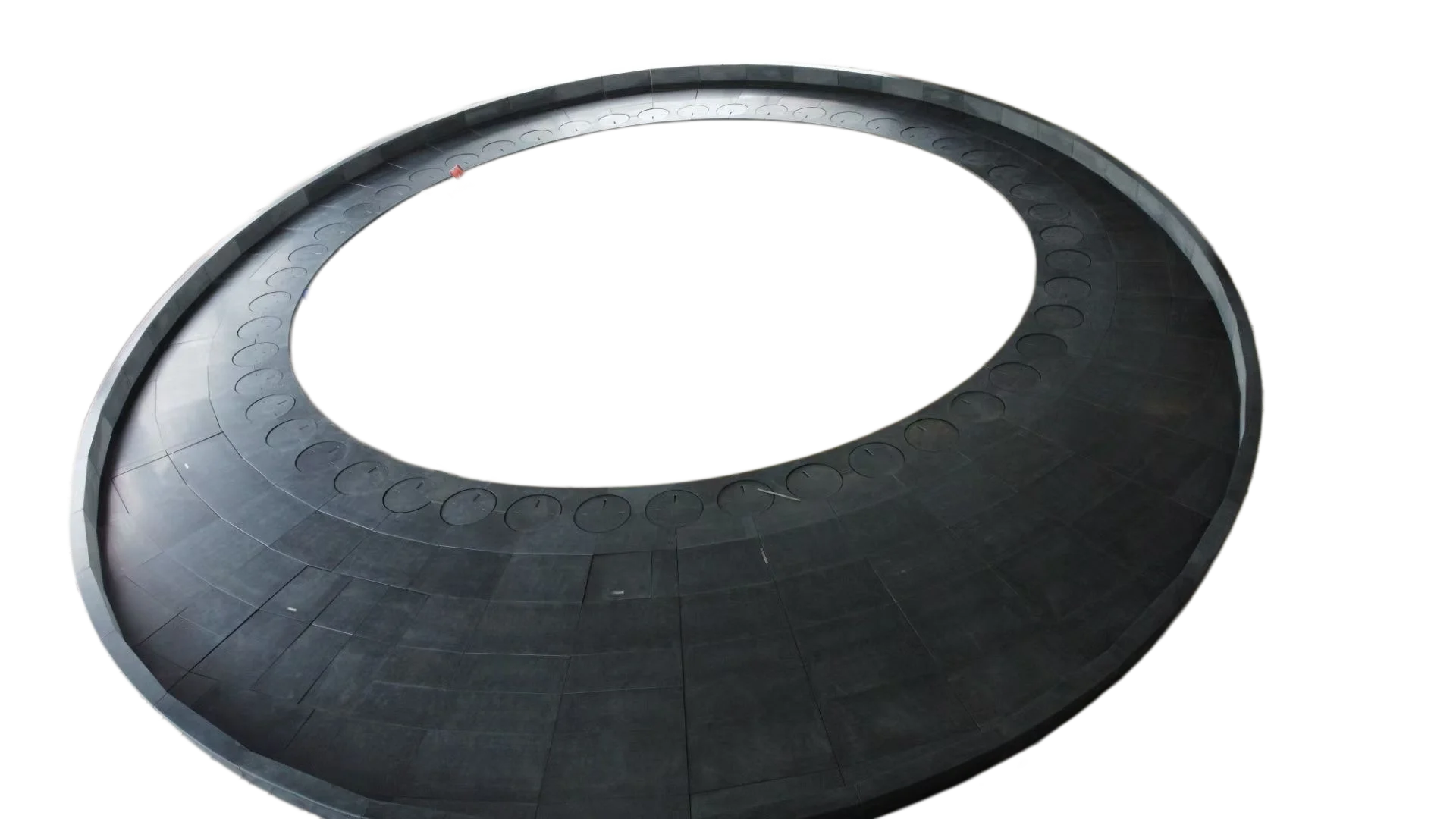 Top-down view of the circular plaza paving: precision-cut radial segments fit tightly to form smooth circular patterns.